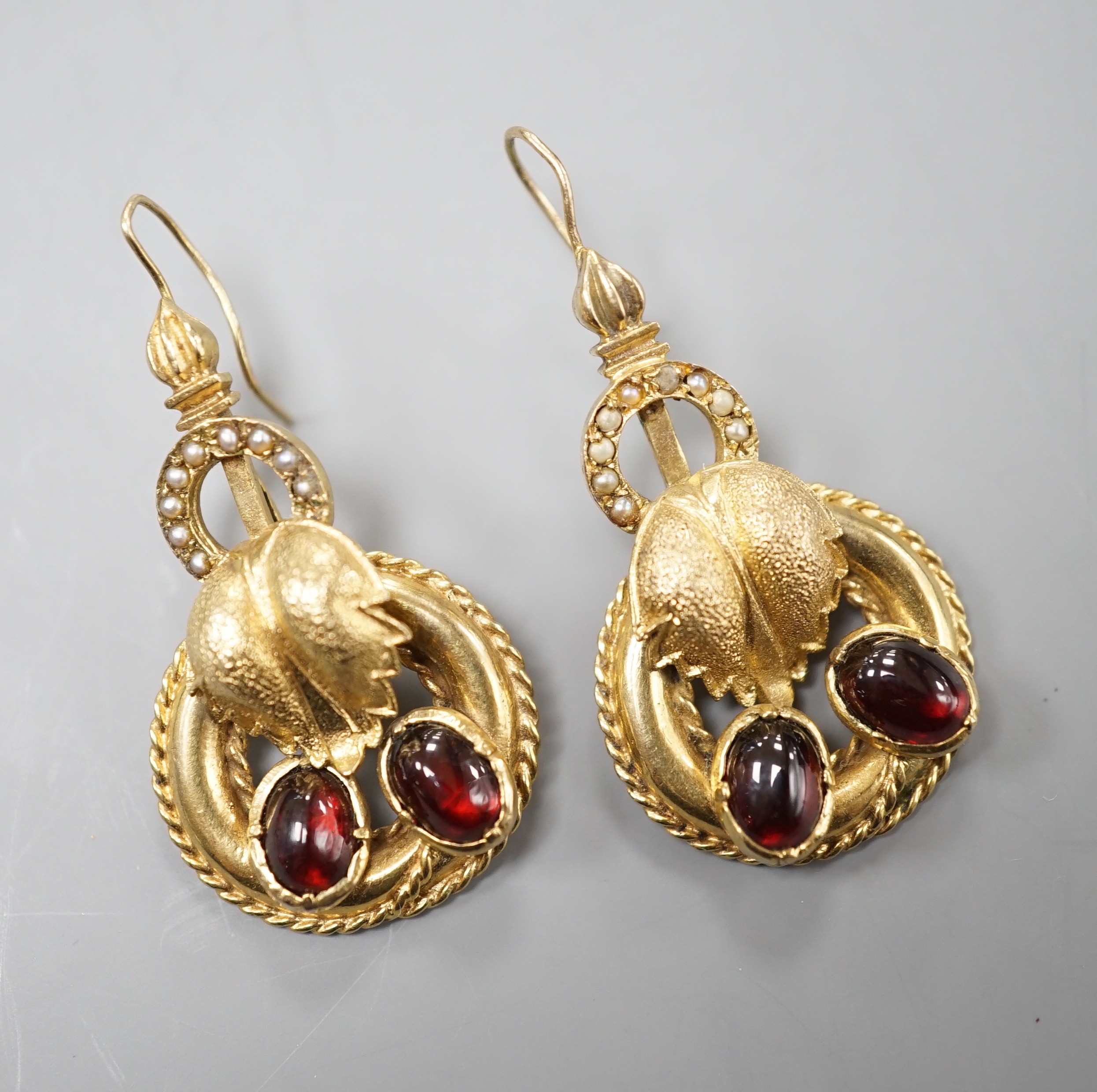 A pair of 375 yellow metal, cabochon garnet paste? and seed pearl set drop earrings, 32mm, gross weight 9.2 grams.